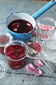 Rose jam in a preserving jar and in a saucepan