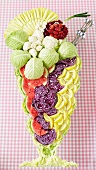 An ice cream sundae made from vegetables, fruit and lettuce