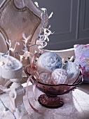 Vintage silver Christmas tree baubles in glass dish with base on Rococo bench