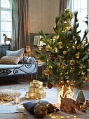 Decorated Christmas tree and presents on floor in front of bench with metal frame in rustic living room