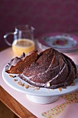 Chocolate cake with slivered almonds, one slice cut