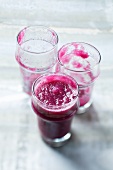 Beetroot smoothie (a full glass and emptied glasses)