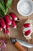 Whole radishes and sliced radishes on bread with salt