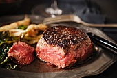 Angus Prime Aged Filet; Sliced on a Plated with Wilted Greens