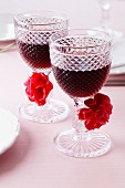 Glasses of red wine decorated with pompoms