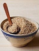 Sesame seeds in a bowl with a spoon