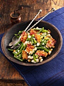 A salad of pears, beans and bacon in a wooden bowl