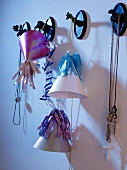 Decorative party hats and necklaces hanging from animal-shaped wall hooks