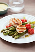 Grilled scallops on asparagus with cherry tomatoes