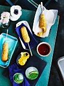 Corn dogs (sausages wrapped in polenta) on sticks