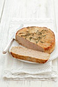 Veal pâté with rosemary, partly sliced