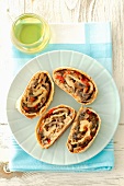 Four slices of mushroom strudel with peppers