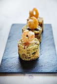 Couscous timbale with vegetables, bacon and prawns