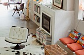 Retro swivel chair in front of masonry fireplace with adjacent bench