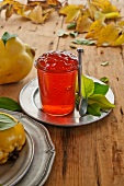 Quince jelly in a glass on a tin plate