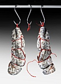 Air-dried salamis hanging from hooks