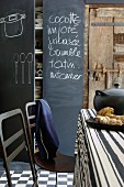 A blackboard with writing on in a rustic kitchen