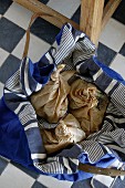 Blue & white striped fabric bag containing paper bags in the kitchen