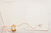 Sheets of writing paper, and a Christmas tree decoration on a narrow ribbon