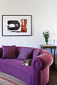 Purple sofa with spiral in upholstery of rolled arm in modern setting