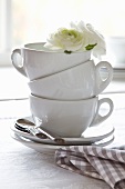 Stacked coffee cups decorated with white flowers