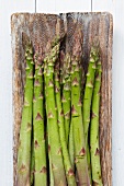 Green asparagus on a rustic wooden board