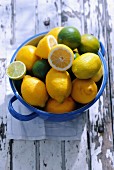 Fresh lemons and limes in a ceramic pot