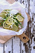 Cod with lemon slices, green beans and fennel, in grease-proof paper