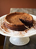Chocolate cake dusted with cocoa powder, sliced
