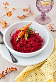 Roasted Beet Risotto with Glazed Carrots and Fresh Dill in a White Bowl