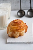 A cinnamon whirl made from puff pastry, with pear filling
