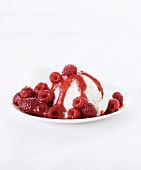 Vanilla ice cream with raspberry syrup and raspberries