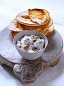 Creamy goat's milk yoghurt with thyme and olives, served with toasted bread
