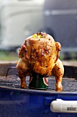A barbecued chicken on a beer can