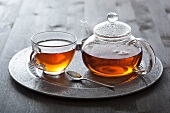 Tea in glass cup and pot