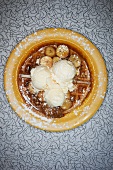 Banana Waffle Topped with Caramelized Bananas, Maple Syrup, Ice Cream and Powdered Sugar; From Above