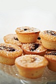 Jam Filled Muffins Dusted with Powdered Sugar on a Glass Cake Stand