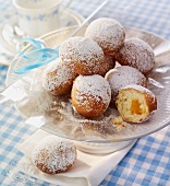 Mini doughnuts with jam filling, dusted with icing sugar