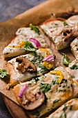Veggie Pizza with Mushrooms, Red Onion and Yellow Peppers; Fresh Basil; Sliced on Parchment Paper