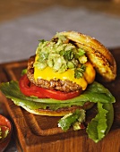 A hamburger with cheddar and avocado