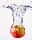 An apple falling into water