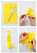 A pompom being made with yellow paper