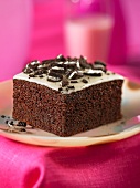A piece of chocolate cake with chocolate biscuit topping