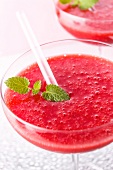 A strawberry Margarita with mint leaves