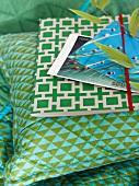 Postcards and folder on pillows and blue and green plaid pattern