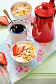 Muesli with strawberries, a cup of coffee