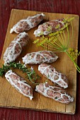 Raw salsiccia sausages with dill and rosemary