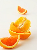 A peeled orange and orange wedges