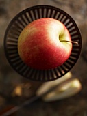 A Pink Lady apple in a dish