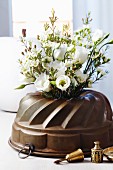 Bundt tin used as vase for lisianthus & waxflowers